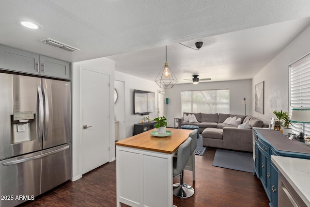 3222 E Cortez St, Phoenix, AZ 85028 - kitchen featuring stainless steel fridge, blue cabinets, butcher block counters, dark wood finished floors, and a textured ceiling