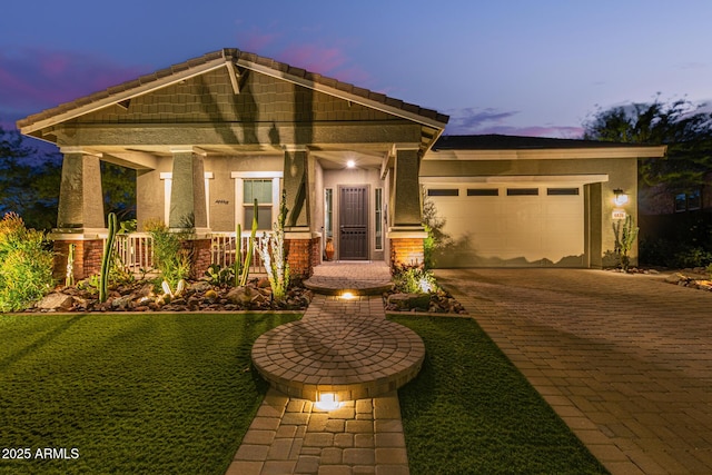 4876 N 207th Ln, Buckeye, AZ 85396 - craftsman-style house with a porch, a garage, decorative driveway, and stucco siding