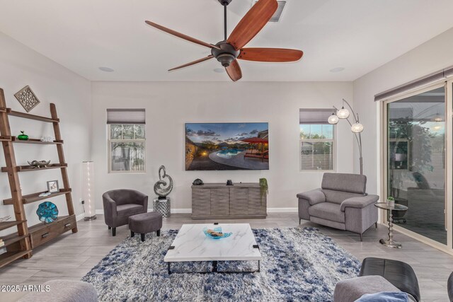 4876 N 207th Ln, Buckeye, AZ 85396 - living room with wood finished floors, baseboards, a ceiling fan, and visible vents
