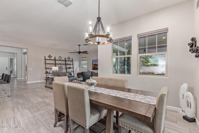 4876 N 207th Ln, Buckeye, AZ 85396 - dining area with ceiling fan with notable chandelier, baseboards, and visible vents