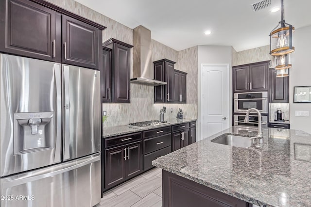 4876 N 207th Ln, Buckeye, AZ 85396 - kitchen featuring dark stone countertops, wall chimney exhaust hood, backsplash, and stainless steel appliances