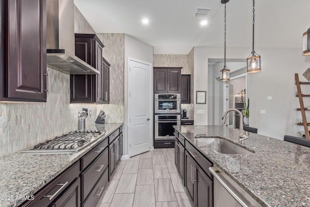 4876 N 207th Ln, Buckeye, AZ 85396 - kitchen with tasteful backsplash, wall chimney range hood, visible vents, appliances with stainless steel finishes, and a sink