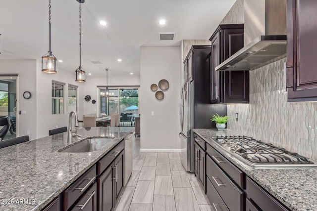 4876 N 207th Ln, Buckeye, AZ 85396 - kitchen with wall chimney range hood, visible vents, appliances with stainless steel finishes, a sink, and backsplash