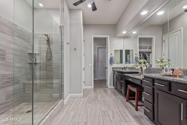4876 N 207th Ln, Buckeye, AZ 85396 - full bath with a sink, ceiling fan, a shower stall, and double vanity