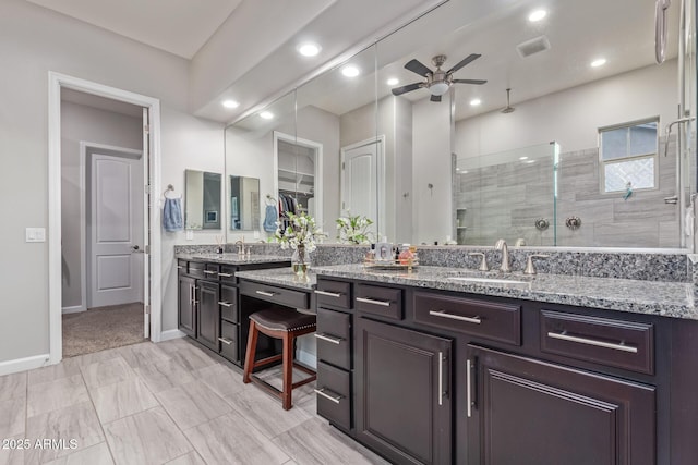 4876 N 207th Ln, Buckeye, AZ 85396 - bathroom featuring a tile shower, vanity, a ceiling fan, recessed lighting, and baseboards