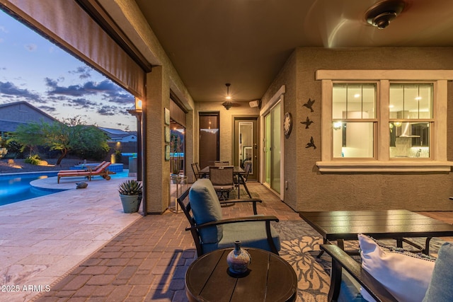 4876 N 207th Ln, Buckeye, AZ 85396 - patio terrace at dusk with outdoor dining area and an outdoor pool