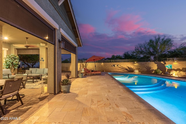 4876 N 207th Ln, Buckeye, AZ 85396 - pool at dusk featuring a fenced in pool, a patio, an outdoor hangout area, and a fenced backyard
