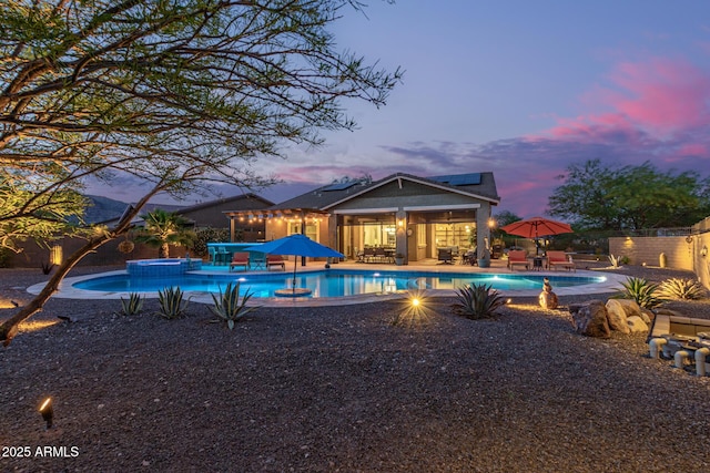 4876 N 207th Ln, Buckeye, AZ 85396 - view of swimming pool with a patio area, a pool with connected hot tub, and a fenced backyard