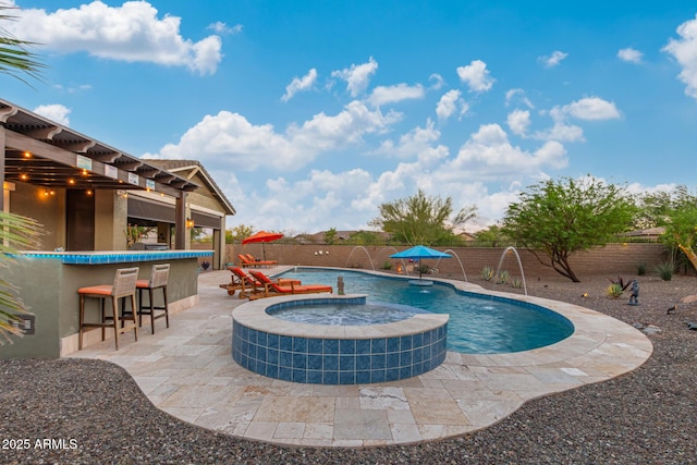 4876 N 207th Ln, Buckeye, AZ 85396 - view of pool with a patio, outdoor dry bar, a fenced backyard, and a pool with connected hot tub