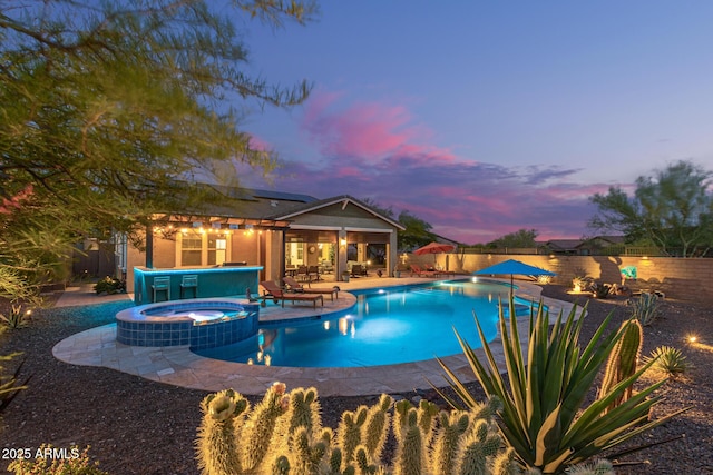 4876 N 207th Ln, Buckeye, AZ 85396 - view of pool with a patio, a fenced backyard, and a pool with connected hot tub