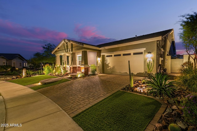 4876 N 207th Ln, Buckeye, AZ 85396 - view of front facade featuring a garage, stucco siding, fence, and decorative driveway