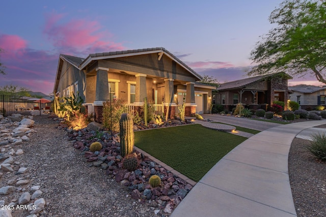 4876 N 207th Ln, Buckeye, AZ 85396 - view of front facade with a yard, an attached garage, fence, stucco siding, and driveway