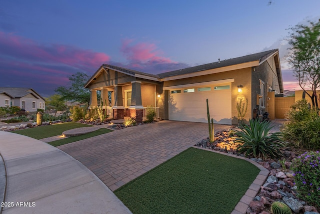 4876 N 207th Ln, Buckeye, AZ 85396 - view of front facade featuring a yard, stucco siding, decorative driveway, fence, and a garage