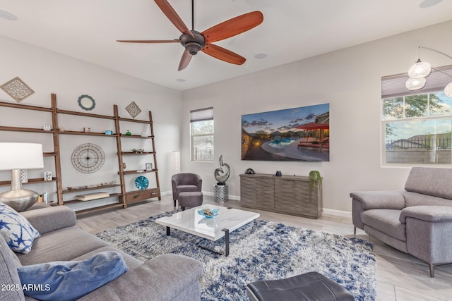 4876 N 207th Ln, Buckeye, AZ 85396 - living area featuring baseboards, a ceiling fan, wood finished floors, and a healthy amount of sunlight