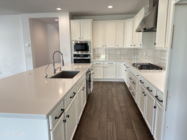 6947 W Spur Dr, Peoria, AZ 85383 - kitchen with wall chimney range hood, a sink, built in microwave, dark wood-style floors, and stainless steel oven