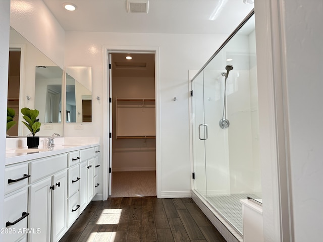 6947 W Spur Dr, Peoria, AZ 85383 - full bath with wood finished floors, a shower stall, vanity, a spacious closet, and recessed lighting