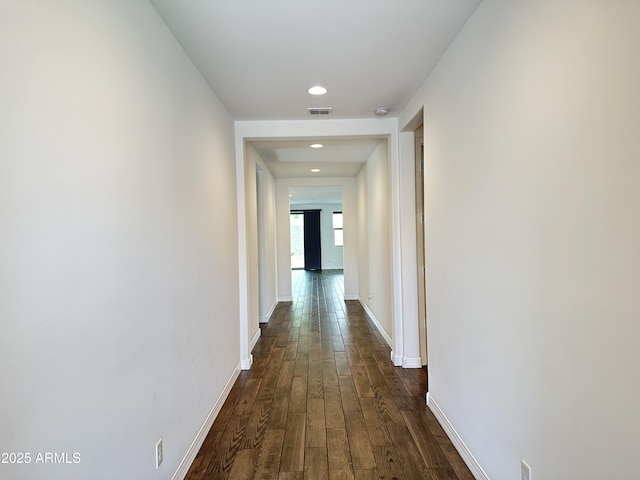 6947 W Spur Dr, Peoria, AZ 85383 - hall featuring dark wood-style flooring, baseboards, and recessed lighting