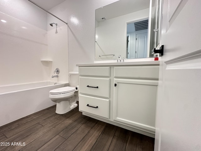 6947 W Spur Dr, Peoria, AZ 85383 - bathroom with toilet, vanity, bathtub / shower combination, and wood finished floors