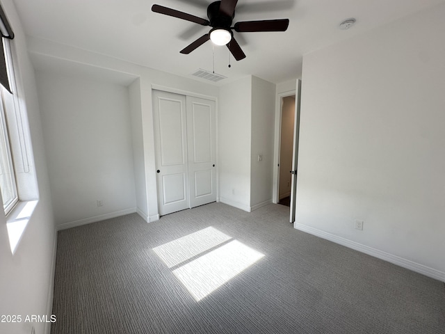 6947 W Spur Dr, Peoria, AZ 85383 - unfurnished bedroom featuring light colored carpet, a closet, baseboards, and a ceiling fan