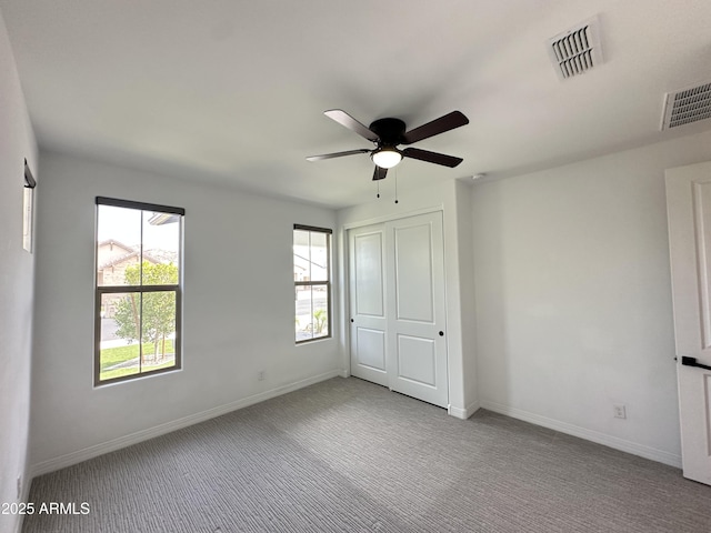 6947 W Spur Dr, Peoria, AZ 85383 - unfurnished bedroom with multiple windows, carpet floors, and baseboards