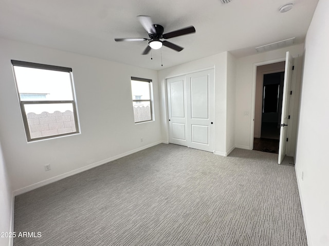 6947 W Spur Dr, Peoria, AZ 85383 - unfurnished bedroom with light carpet, a closet, baseboards, and ceiling fan