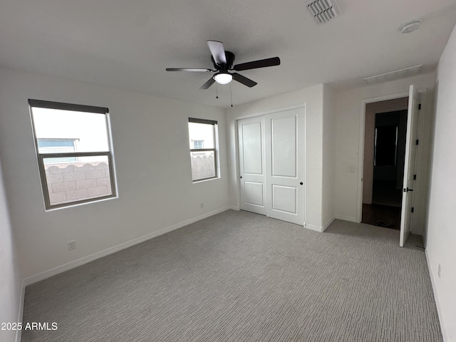 6947 W Spur Dr, Peoria, AZ 85383 - unfurnished bedroom featuring a closet, light carpet, baseboards, and a ceiling fan