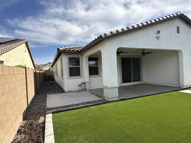 6947 W Spur Dr, Peoria, AZ 85383 - rear view of house featuring a ceiling fan, stucco siding, a patio, and a tiled roof