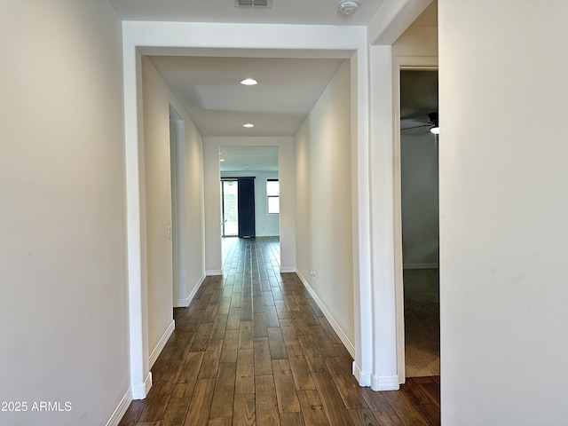 6947 W Spur Dr, Peoria, AZ 85383 - hallway featuring dark wood-style flooring, baseboards, and recessed lighting