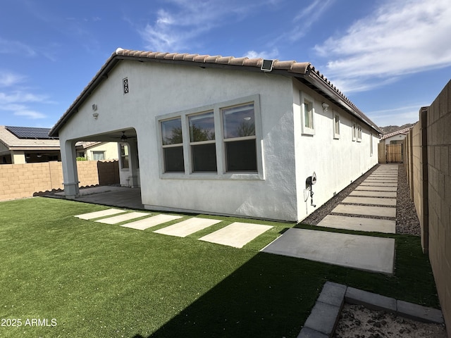 6947 W Spur Dr, Peoria, AZ 85383 - rear view of house featuring stucco siding and a patio area