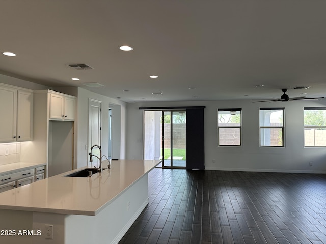 6947 W Spur Dr, Peoria, AZ 85383 - kitchen featuring open floor plan, a sink, baseboards, white cabinets, and recessed lighting