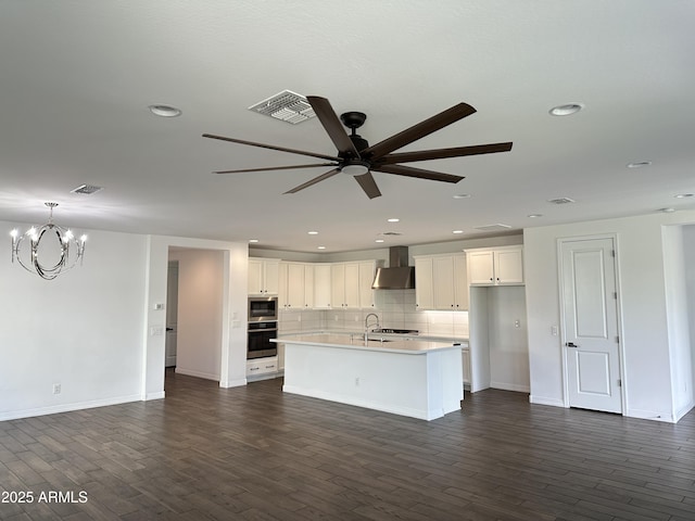 6947 W Spur Dr, Peoria, AZ 85383 - kitchen with wall chimney range hood, stainless steel appliances, a ceiling fan, a chandelier, and recessed lighting