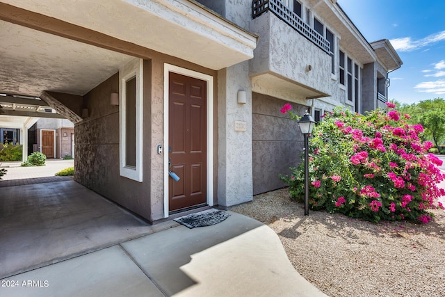 entrance to property featuring stucco siding