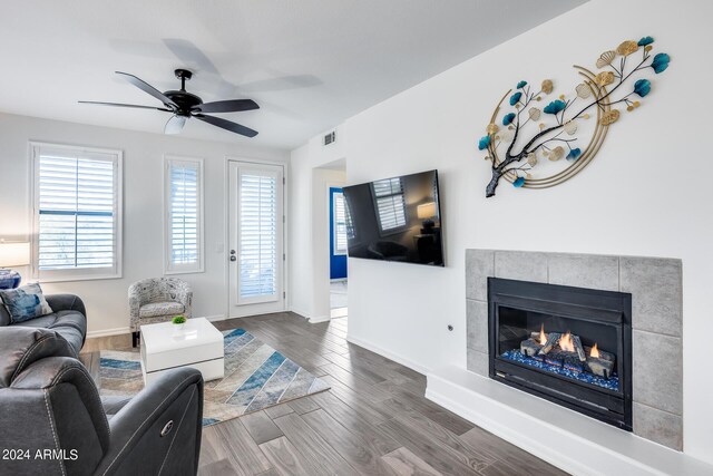 living room with ceiling fan, hardwood / wood-style flooring, and a fireplace