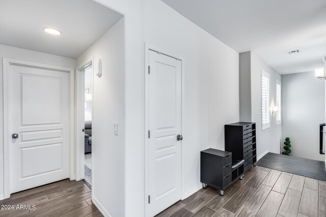 corridor with dark hardwood / wood-style flooring