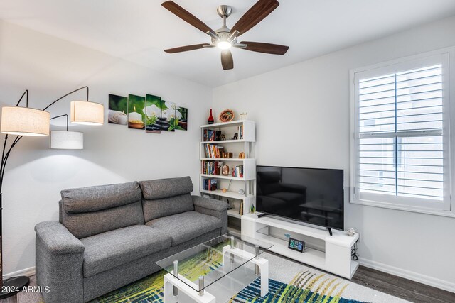 living room featuring a healthy amount of sunlight, ceiling fan, and wood-type flooring