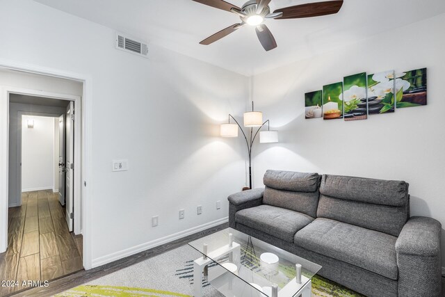 living room featuring dark hardwood / wood-style flooring and ceiling fan