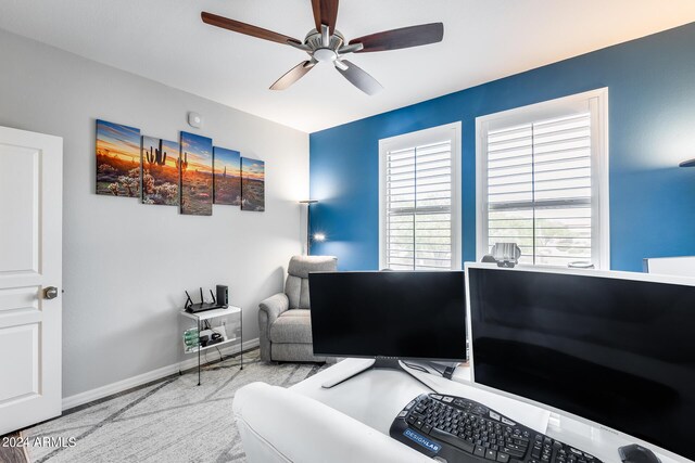 carpeted office space with ceiling fan