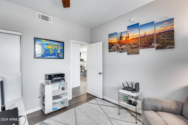 sitting room featuring ceiling fan and hardwood / wood-style flooring