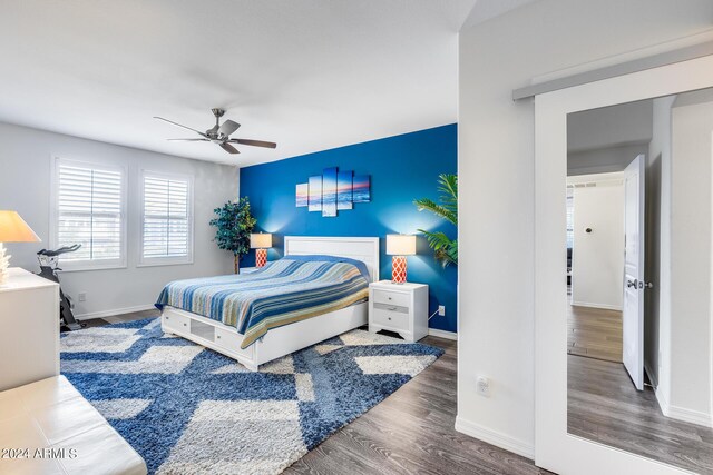 bedroom with ceiling fan and dark hardwood / wood-style floors