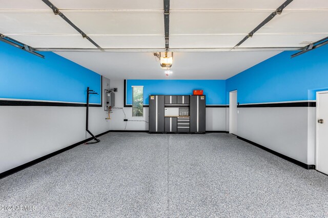 garage featuring a garage door opener and electric water heater