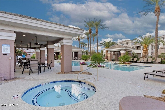 view of swimming pool with a patio area and a hot tub