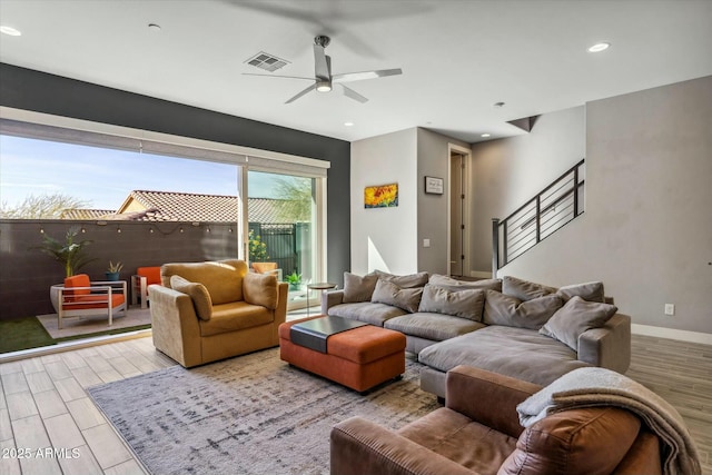 living room with ceiling fan and light wood-type flooring