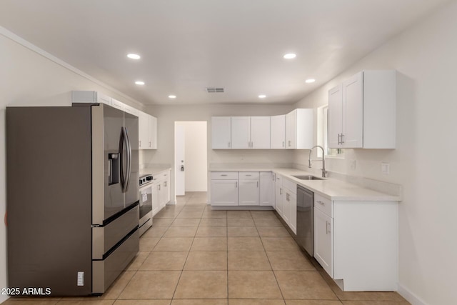 kitchen featuring stainless steel appliances, recessed lighting, visible vents, white cabinetry, and a sink