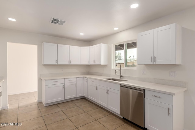 kitchen featuring a sink, visible vents, white cabinetry, light countertops, and stainless steel dishwasher