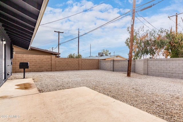 view of yard with a fenced backyard and a patio