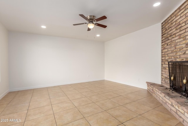 unfurnished living room with a brick fireplace, ceiling fan, light tile patterned floors, and recessed lighting