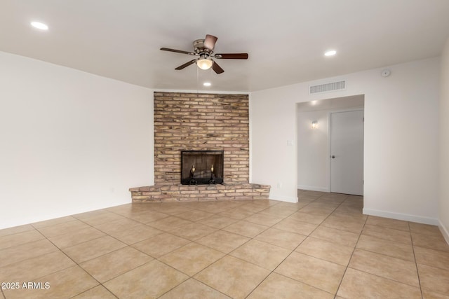 unfurnished living room with light tile patterned floors, ceiling fan, a fireplace, and visible vents