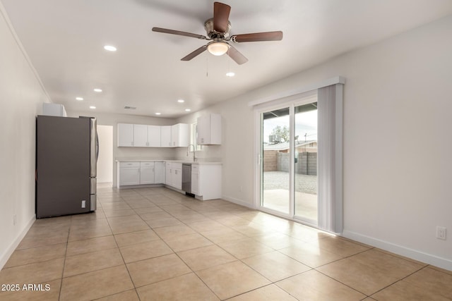 kitchen with baseboards, white cabinets, appliances with stainless steel finishes, light countertops, and recessed lighting