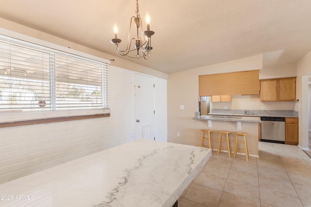 4565 Aspen Dr, Sierra Vista, AZ 85635 - kitchen featuring lofted ceiling, hanging light fixtures, stainless steel appliances, a breakfast bar, and light tile patterned floors
