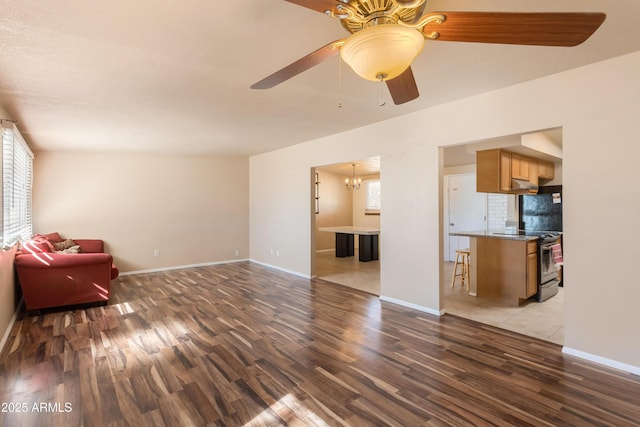 4565 Aspen Dr, Sierra Vista, AZ 85635 - living room with ceiling fan with notable chandelier and dark hardwood / wood-style floors